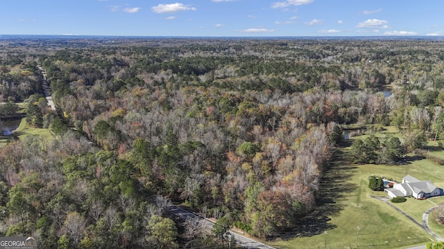 birds eye view of property featuring a view of trees