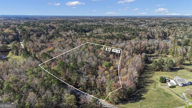 aerial view featuring a wooded view