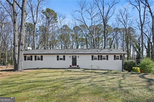 single story home featuring a front lawn and brick siding