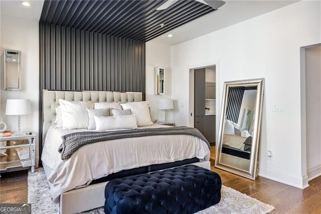 bedroom with recessed lighting, dark wood finished floors, and baseboards