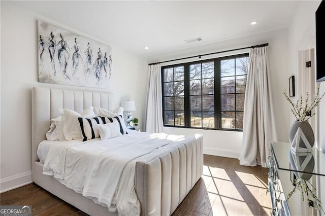 bedroom with recessed lighting, wood finished floors, and baseboards