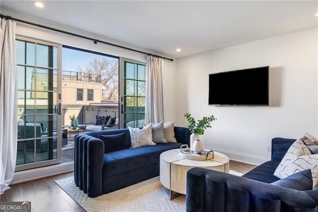 living area with recessed lighting, wood finished floors, and baseboards