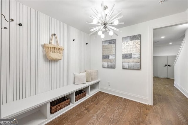 mudroom featuring a notable chandelier, baseboards, and wood finished floors