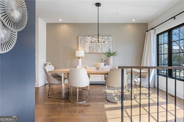 dining space featuring baseboards, wood finished floors, and recessed lighting