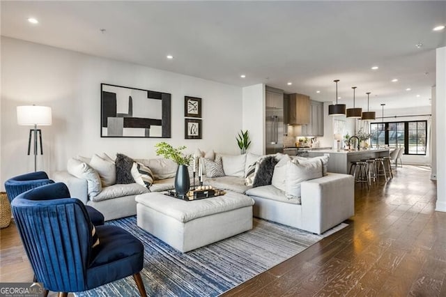 living area with dark wood finished floors and recessed lighting