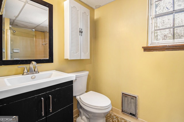 bathroom with a drop ceiling, toilet, visible vents, vanity, and baseboards