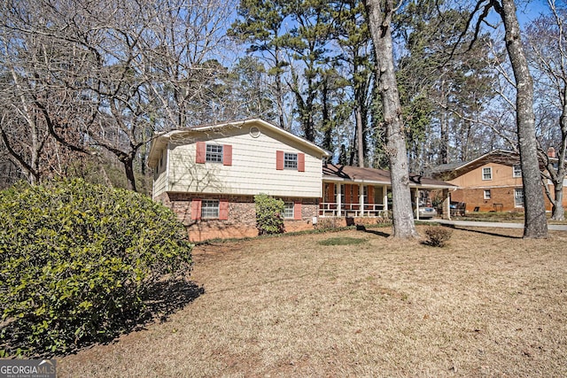 exterior space featuring brick siding and a yard