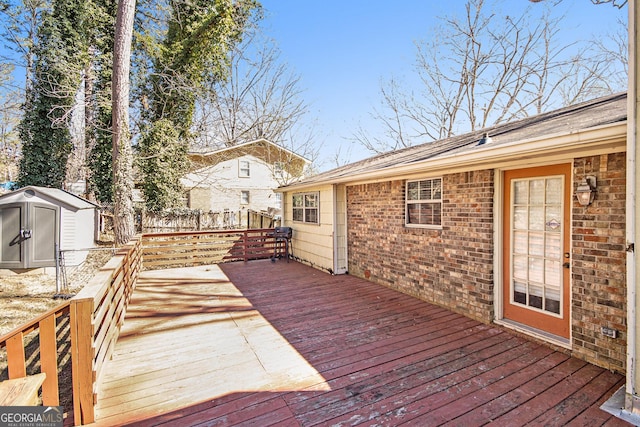 deck with an outbuilding, fence, and a shed