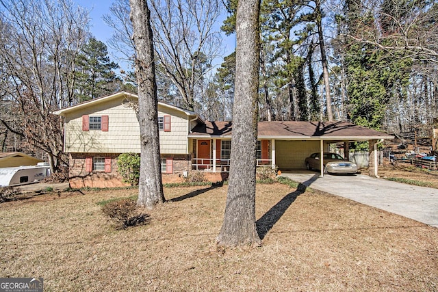 split level home featuring concrete driveway, a carport, and fence