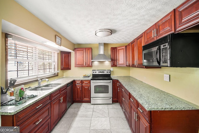 kitchen with stainless steel appliances, a sink, dark brown cabinets, light stone countertops, and wall chimney exhaust hood