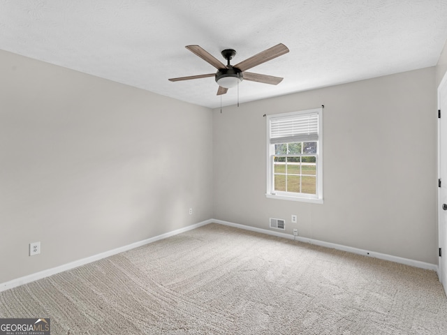 unfurnished room with baseboards, visible vents, ceiling fan, a textured ceiling, and carpet flooring