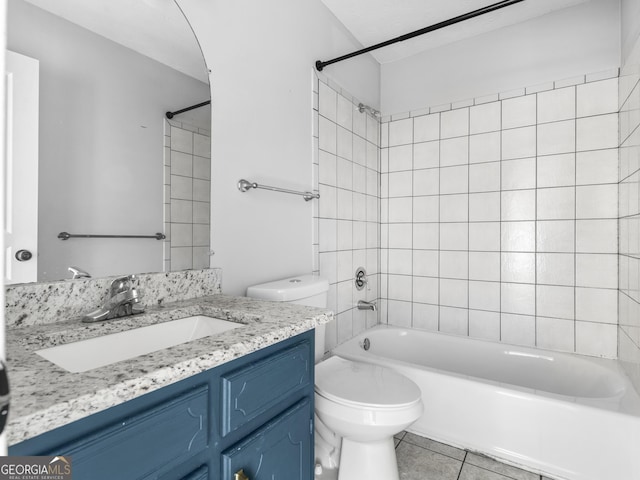 full bath featuring toilet, tile patterned floors, tub / shower combination, and vanity