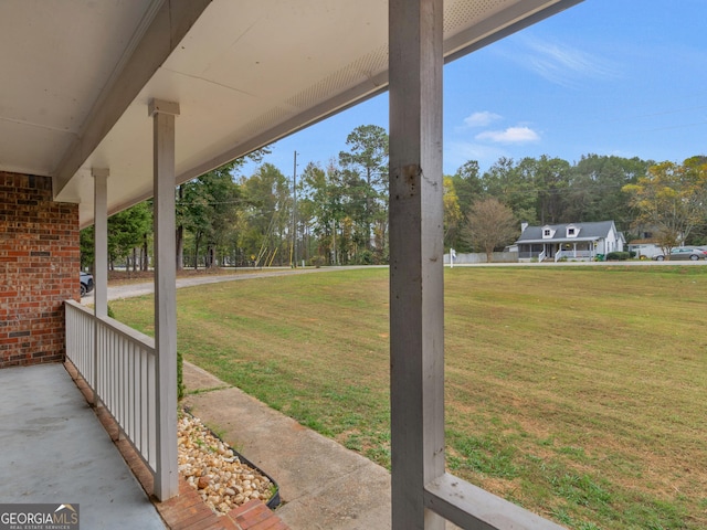 view of yard featuring covered porch