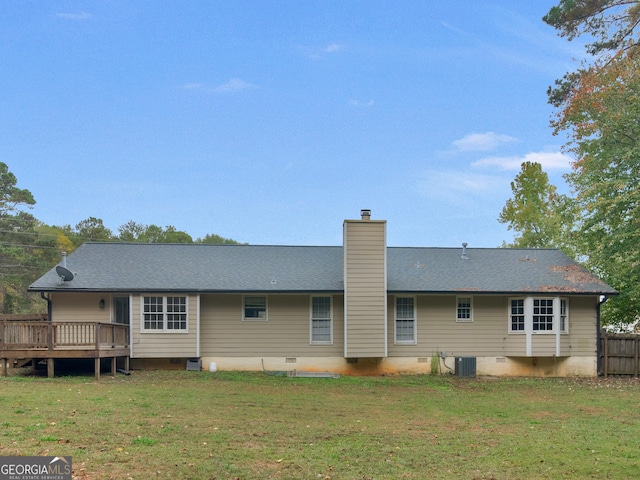 back of house with a deck, crawl space, a chimney, and a lawn