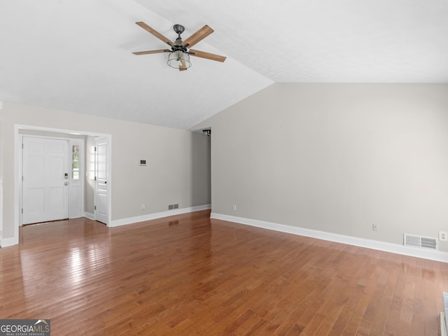 unfurnished living room featuring a ceiling fan, visible vents, vaulted ceiling, and wood finished floors