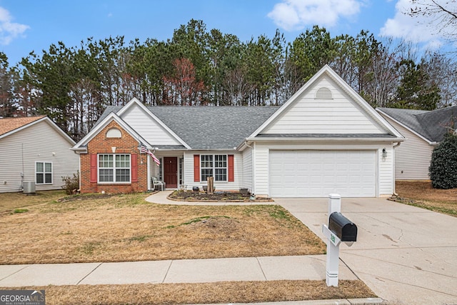 view of front facade with an attached garage, brick siding, a shingled roof, concrete driveway, and a front yard