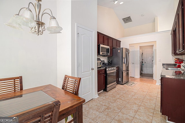 kitchen featuring light tile patterned floors, visible vents, appliances with stainless steel finishes, a chandelier, and a sink