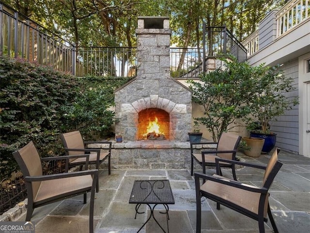 view of patio with an outdoor stone fireplace