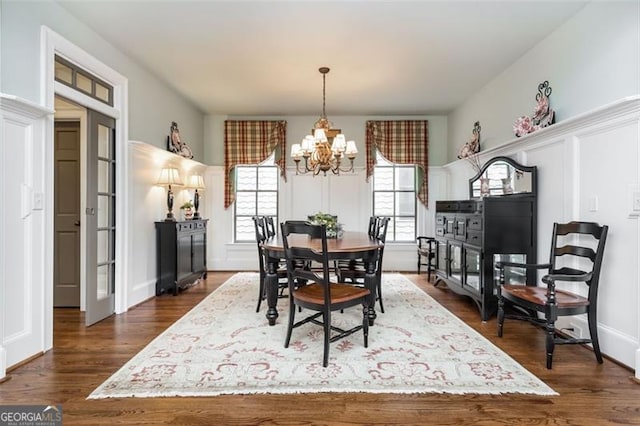 dining room featuring dark wood-type flooring and a notable chandelier
