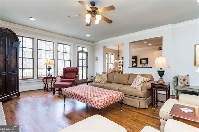living area with crown molding, wood finished floors, ceiling fan, and recessed lighting