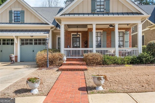 view of front of property with covered porch, a garage, board and batten siding, brick siding, and driveway