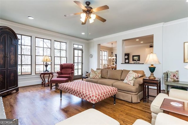 living area with a ceiling fan, ornamental molding, wood finished floors, and recessed lighting