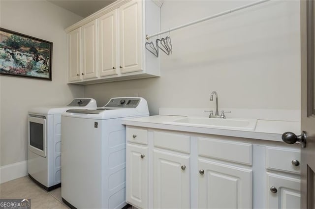 laundry room featuring baseboards, separate washer and dryer, a sink, cabinet space, and light tile patterned flooring