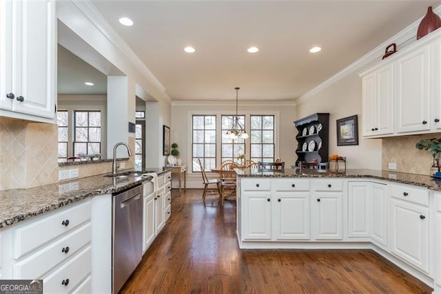 kitchen featuring a peninsula, a sink, white cabinetry, and stainless steel dishwasher