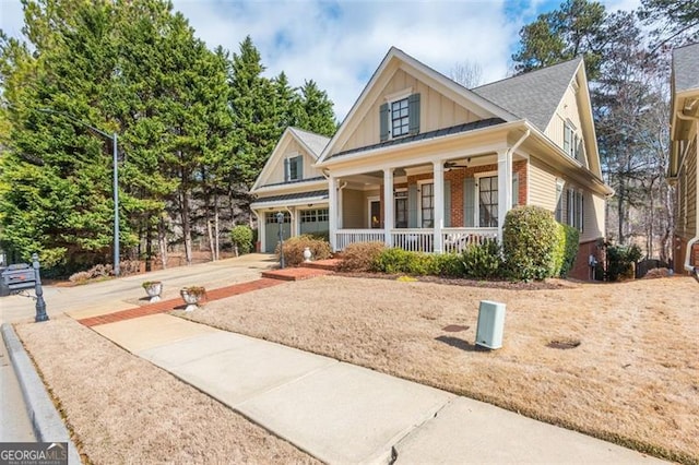 view of front facade with brick siding, a porch, concrete driveway, an attached garage, and board and batten siding