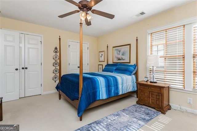 bedroom with carpet floors, a ceiling fan, visible vents, and baseboards