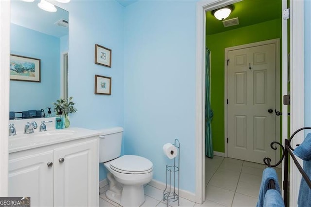 bathroom featuring baseboards, visible vents, toilet, tile patterned floors, and vanity