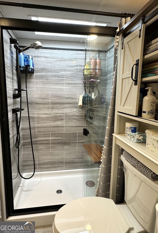 bathroom featuring a stall shower and toilet