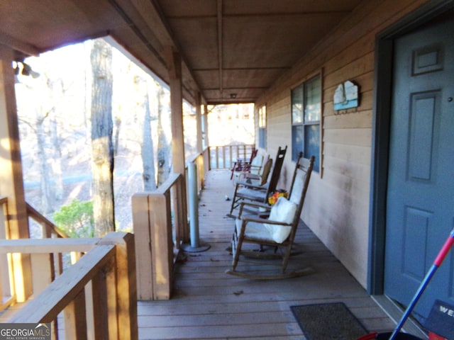 wooden terrace featuring a porch