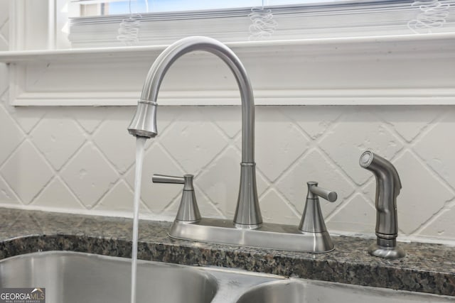 interior details featuring dark stone counters and a sink