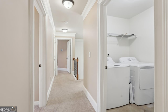 washroom with crown molding, light carpet, separate washer and dryer, laundry area, and baseboards