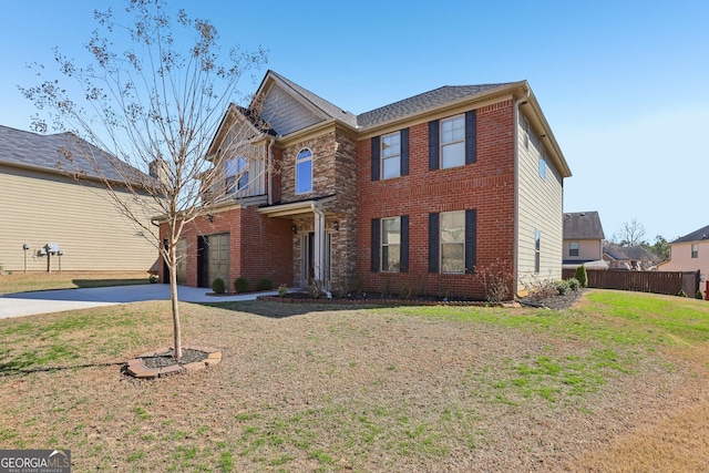 view of front facade featuring a garage, a front yard, concrete driveway, and brick siding