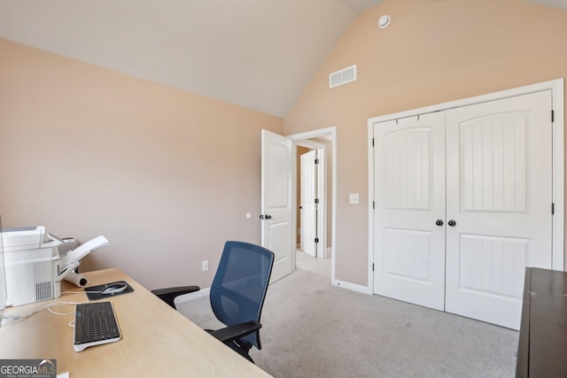 office space with high vaulted ceiling, baseboards, visible vents, and light colored carpet