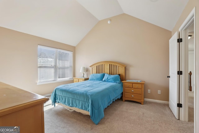 bedroom with lofted ceiling, light carpet, and baseboards