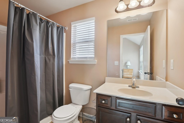 full bathroom featuring toilet, vanity, and visible vents