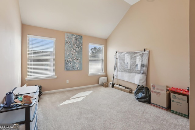 interior space featuring lofted ceiling, carpet, and baseboards