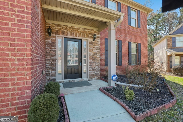 view of exterior entry with brick siding