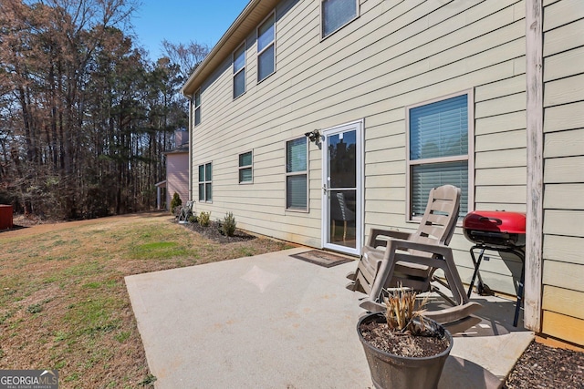 back of property with a patio and a lawn