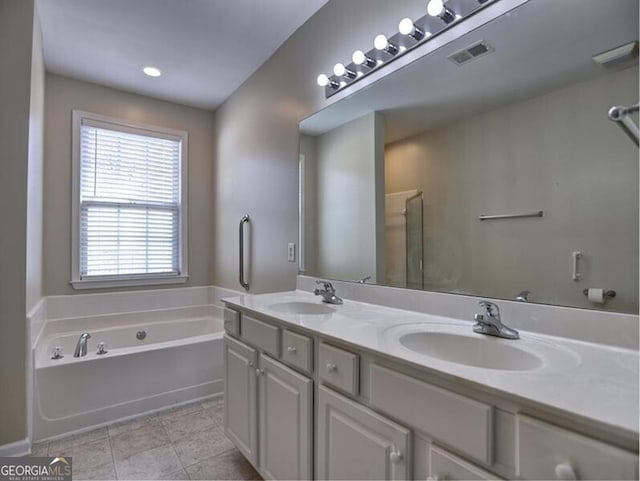 full bath featuring tile patterned flooring, a sink, a bath, and double vanity