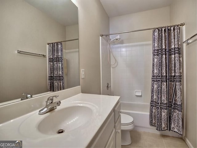 full bath with shower / tub combo with curtain, toilet, vanity, and tile patterned floors