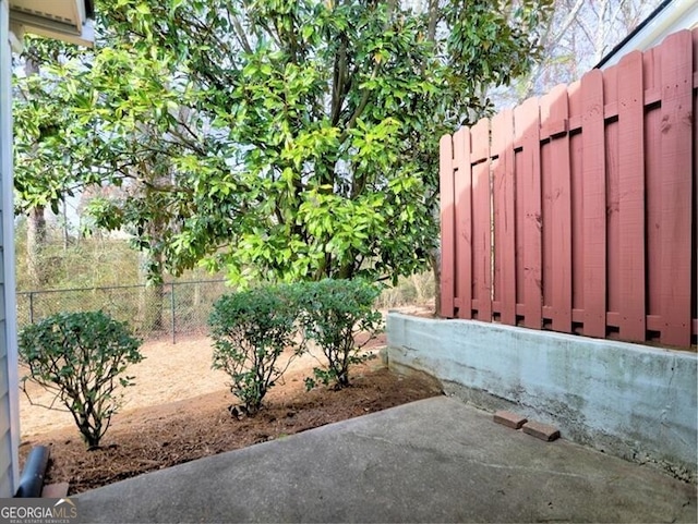 view of yard featuring a patio and fence