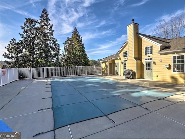 view of pool with fence, area for grilling, a fenced in pool, and a patio