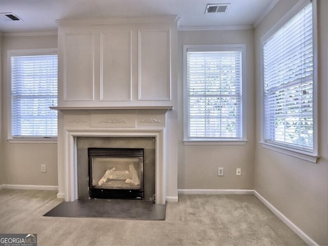 room details featuring a fireplace with flush hearth, visible vents, crown molding, and carpet flooring