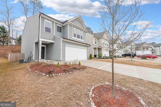 view of front facade with a residential view, cooling unit, driveway, and an attached garage