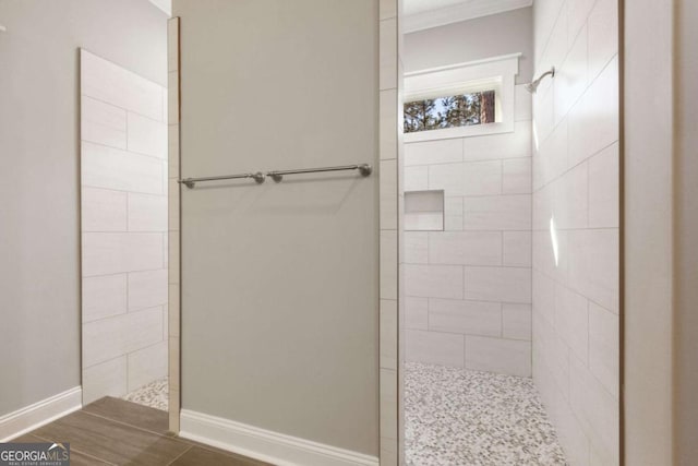 bathroom with baseboards and a walk in shower