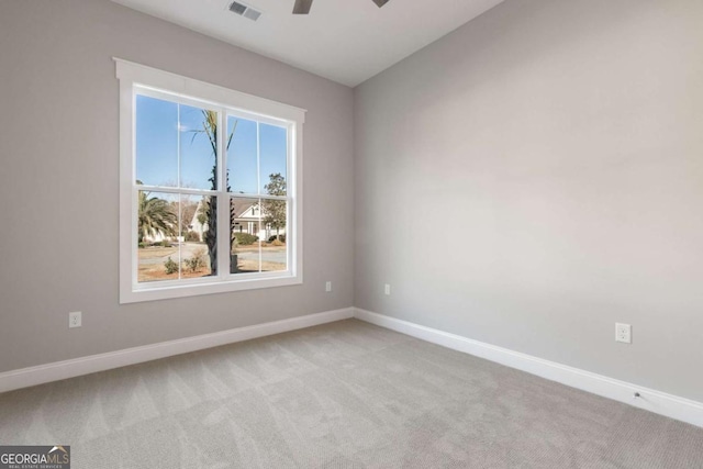 unfurnished room with light carpet, ceiling fan, visible vents, and baseboards